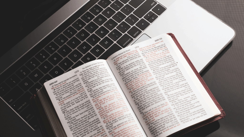 open bible on top of laptop